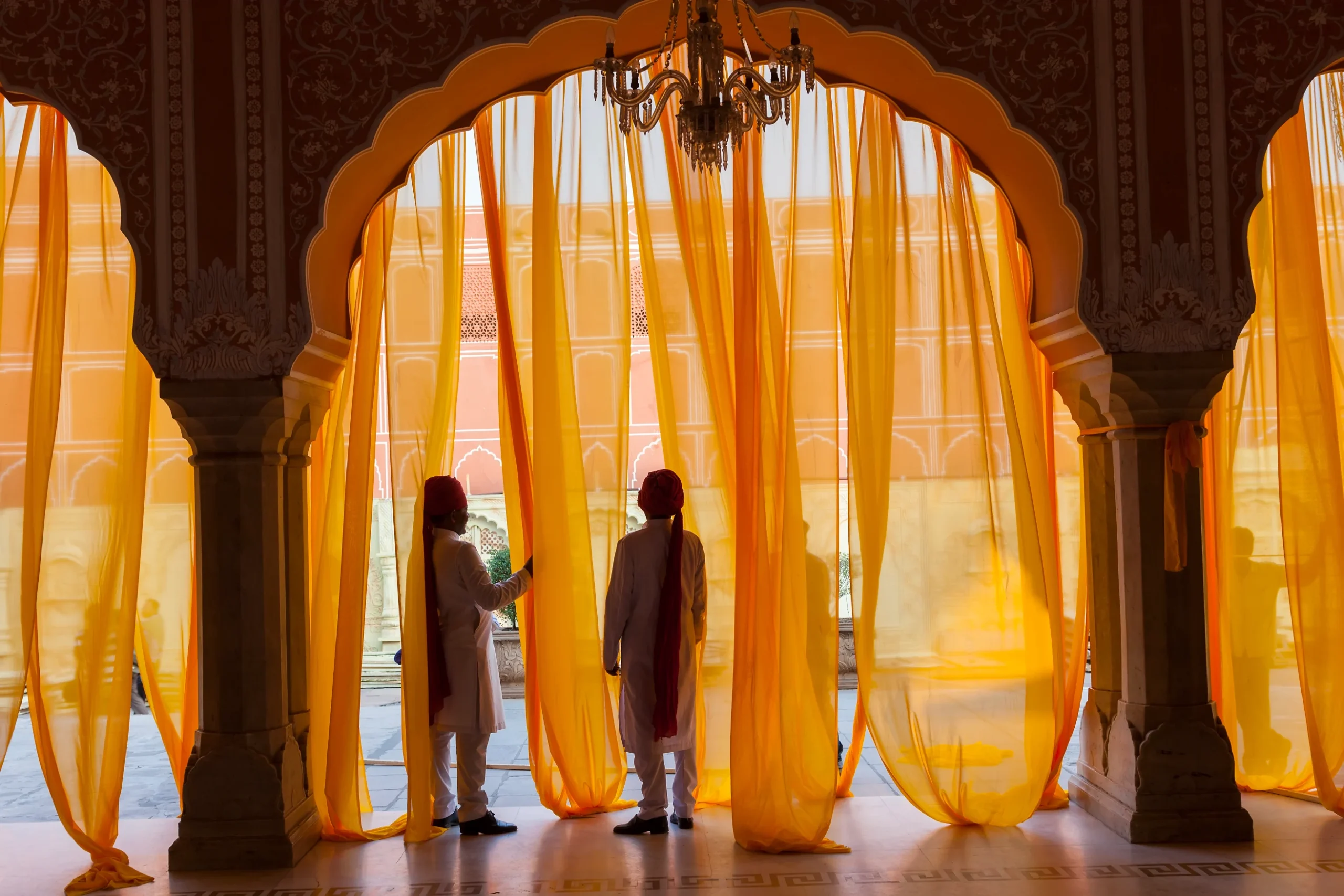 tourists-in-building-with-pillars-and-curtains-2026-03-25-03-21-15-utc